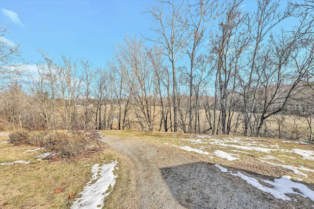 a view of a house with a yard covered in snow