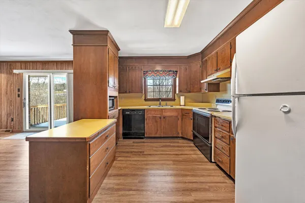 a kitchen with stainless steel appliances granite countertop a sink stove and cabinets