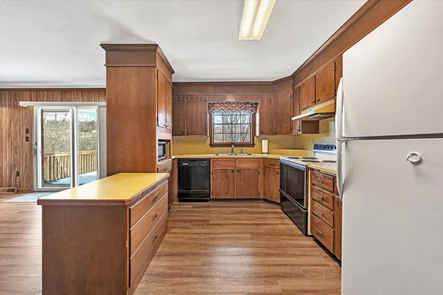 a kitchen with stainless steel appliances granite countertop a sink stove and cabinets