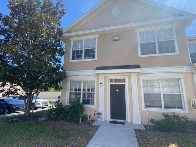 105 Turpial Way, Unit 105 Melbourne, FL 32901 - Photo 1 of 25 front view of a house with a yard
