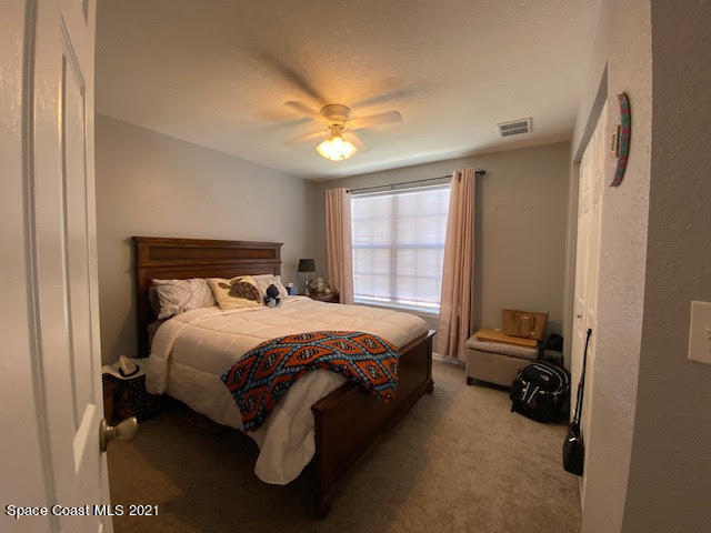 105 Turpial Way, Unit 105 Melbourne, FL 32901 - Photo 12 of 25 a bed room with a bed and a window