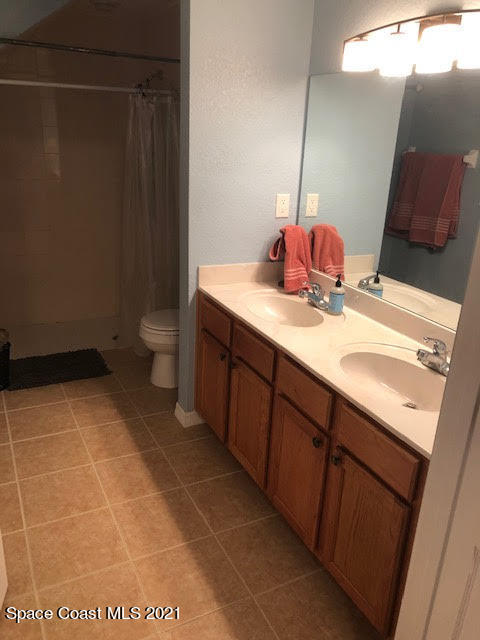 105 Turpial Way, Unit 105 Melbourne, FL 32901 - Photo 19 of 25 a bathroom with a sink toilet and vanity