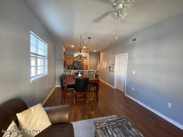 105 Turpial Way, Unit 105 Melbourne, FL 32901 - Photo 3 of 25 a view of a dining room with furniture and wooden floor