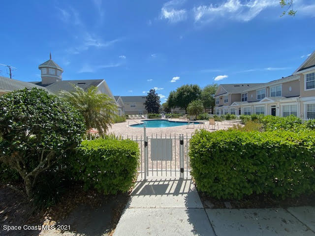 105 Turpial Way, Unit 105 Melbourne, FL 32901 - Photo 21 of 25 a view of a house with a yard and potted plants