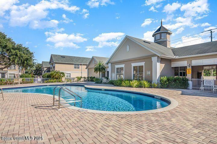 105 Turpial Way, Unit 105 Melbourne, FL 32901 - Photo 22 of 25 a view of a house with swimming pool and sitting area