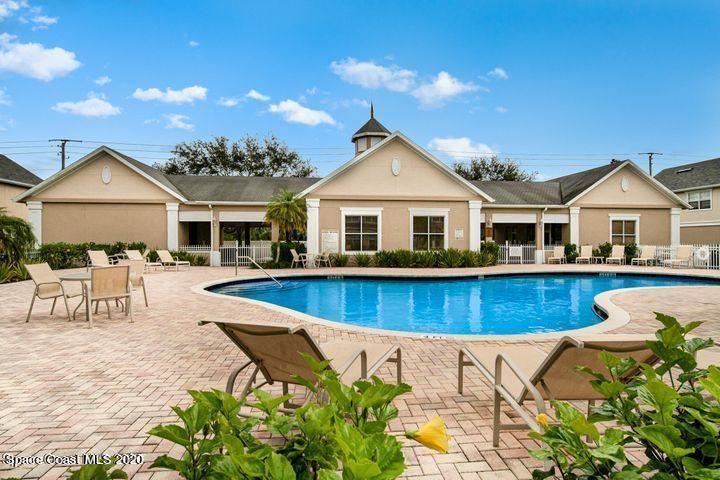 105 Turpial Way, Unit 105 Melbourne, FL 32901 - Photo 23 of 25 a view of a house with pool and chairs