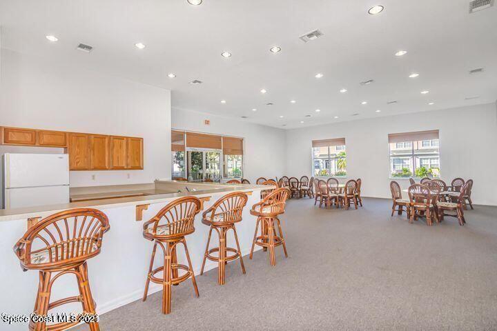 105 Turpial Way, Unit 105 Melbourne, FL 32901 - Photo 25 of 25 a outdoor space with lots of chairs and mirrors
