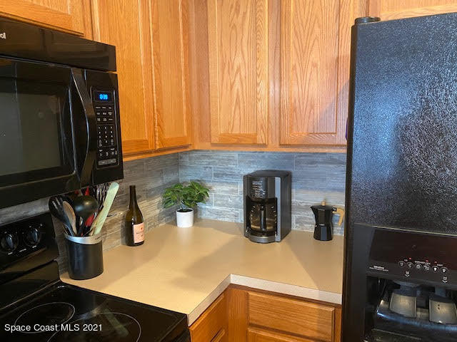 105 Turpial Way, Unit 105 Melbourne, FL 32901 - Photo 7 of 25 a kitchen with a stove and a microwave