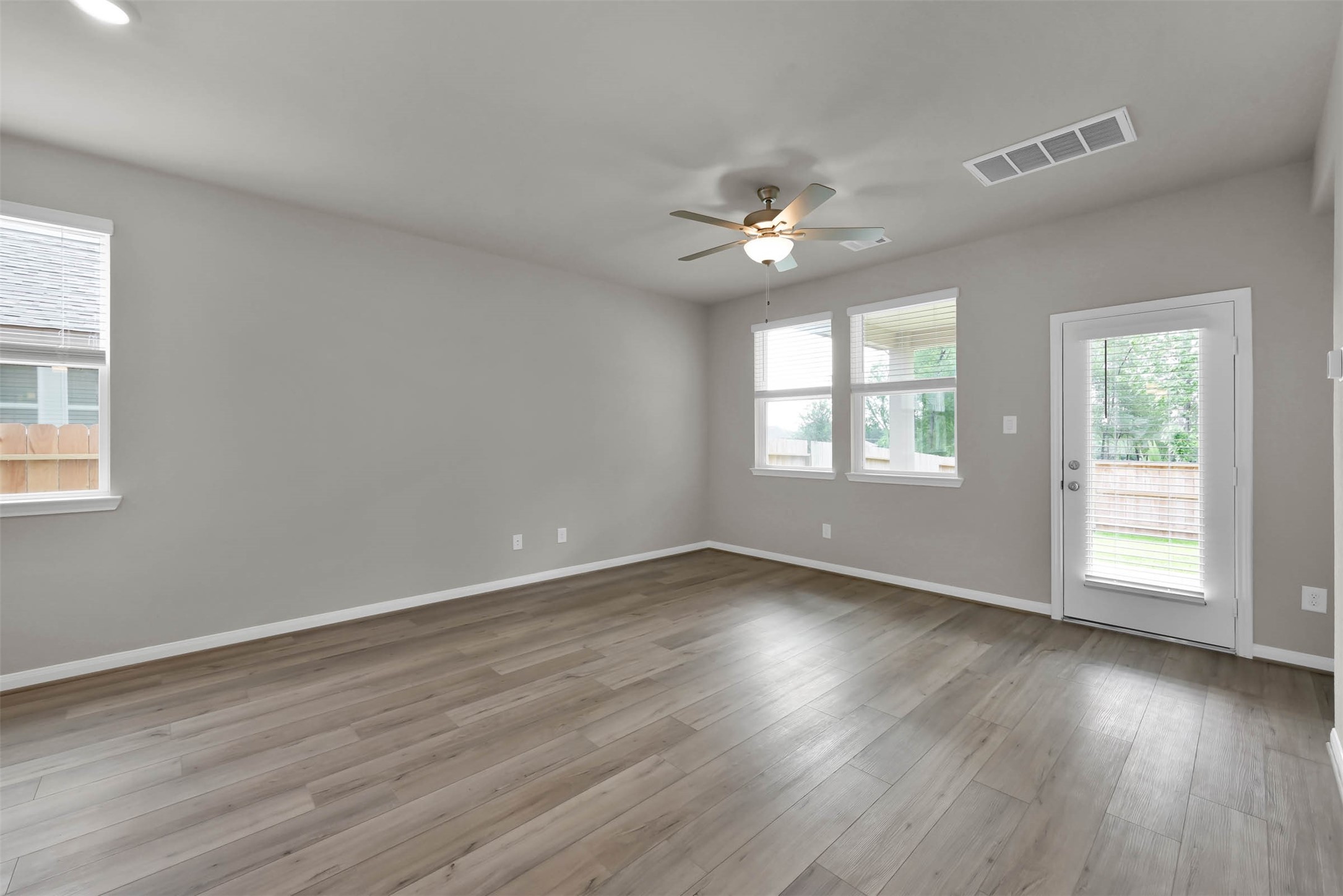 213 Harper Ridge Drive Montgomery, TX 77316 - Photo 14 of 34 a view of an empty room with wooden floor and a window