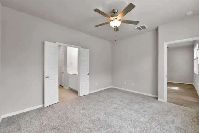 an empty room with fan and a ceiling fan