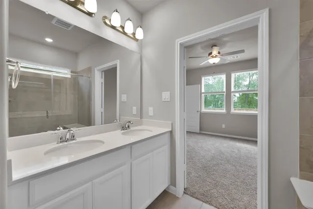 a bathroom with a double vanity sink and a mirror