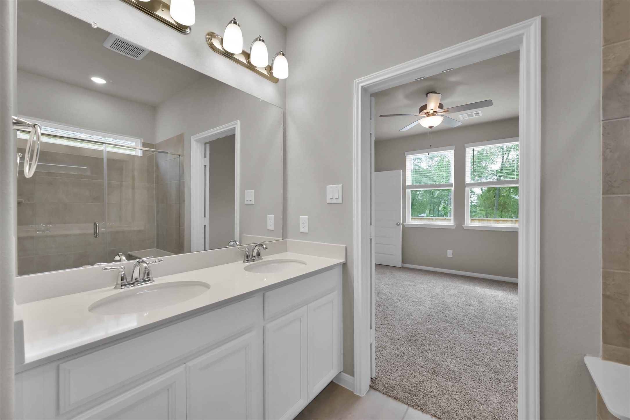 213 Harper Ridge Drive Montgomery, TX 77316 - Photo 18 of 34 a bathroom with a double vanity sink and a mirror