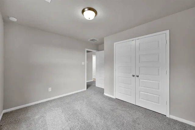 an empty room with closet area