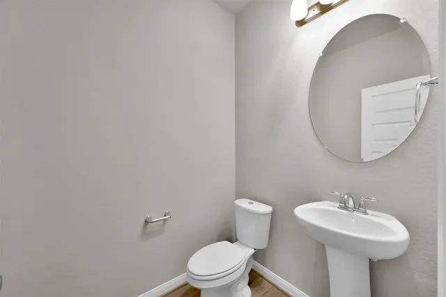 a bathroom with a sink a mirror and a toilet