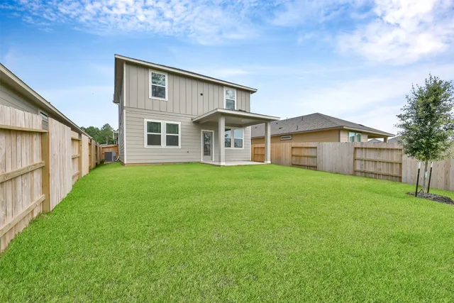 a front view of a house with a garden and yard
