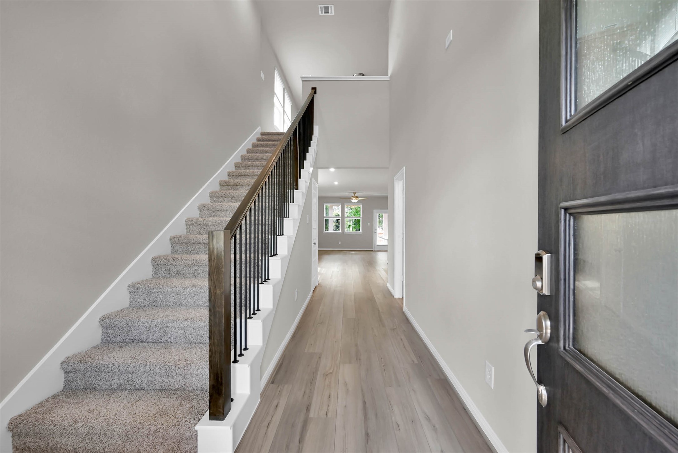 213 Harper Ridge Drive Montgomery, TX 77316 - Photo 4 of 34 a view of a hallway with wooden floor and staircase