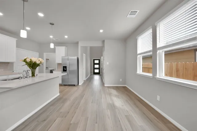 a large kitchen with stainless steel appliances kitchen island a large counter space and a wooden floors