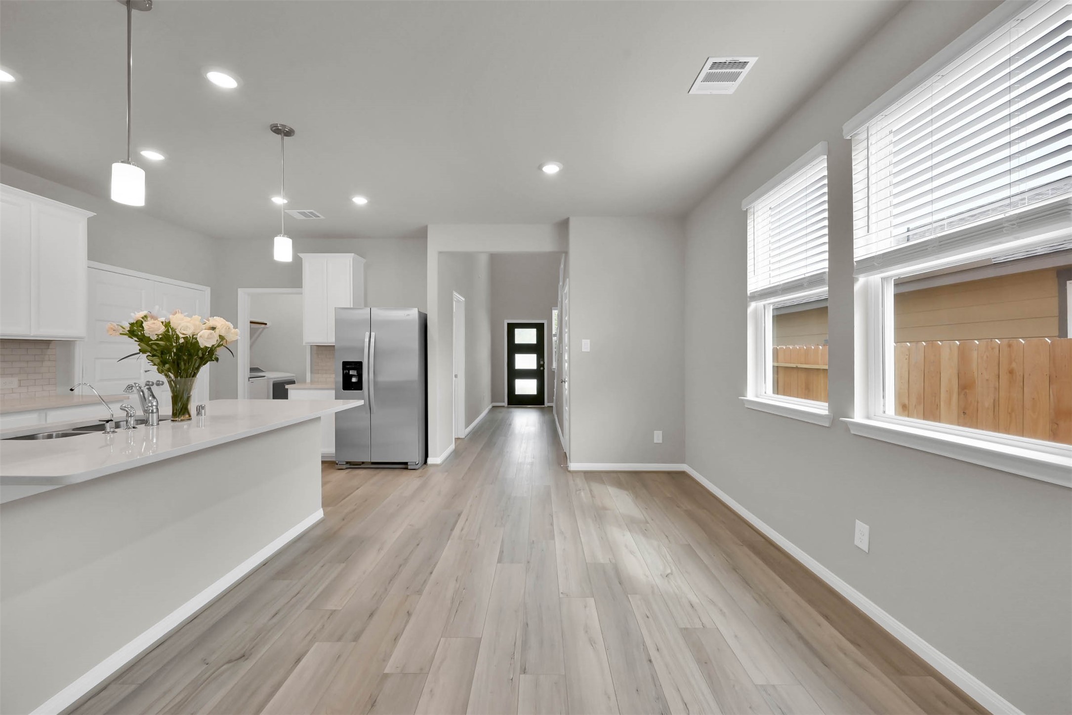213 Harper Ridge Drive Montgomery, TX 77316 - Photo 6 of 34 a large kitchen with stainless steel appliances kitchen island a large counter space and a wooden floors