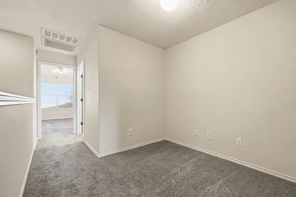 an empty room with a bench and a shower