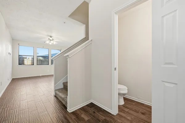 a view of entryway with wooden floor and stairs