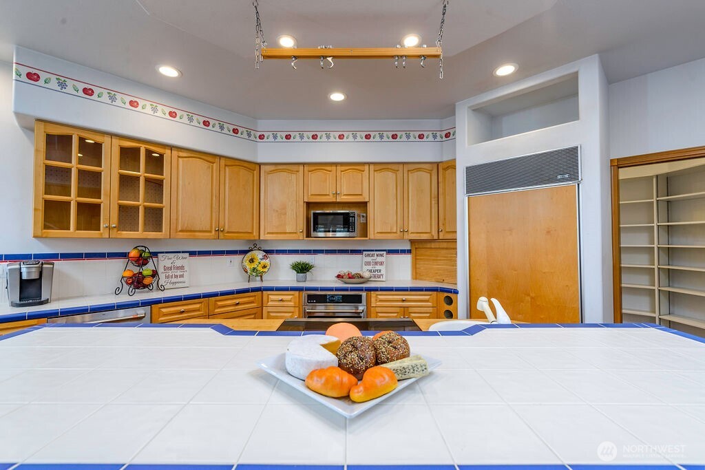 3250 Highway 302 Belfair, WA 98528 - Photo 11 of 40 a kitchen with stainless steel appliances granite countertop a sink and cabinets