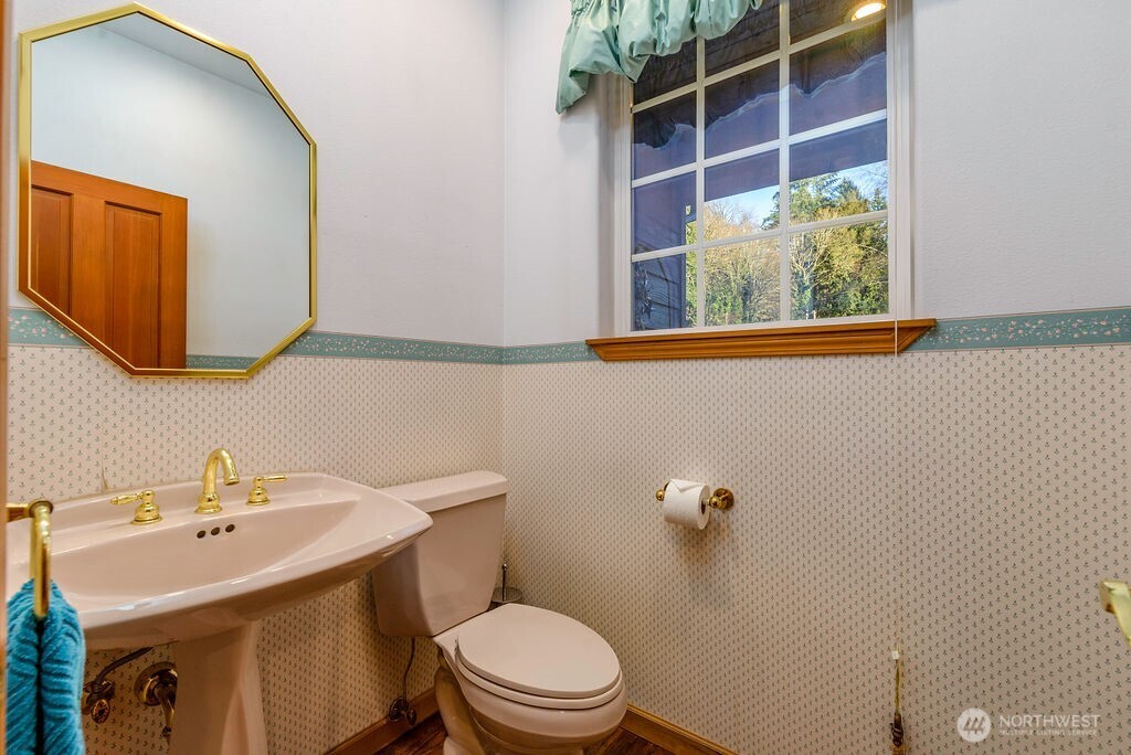3250 Highway 302 Belfair, WA 98528 - Photo 15 of 40 a bathroom with a sink a toilet and mirror