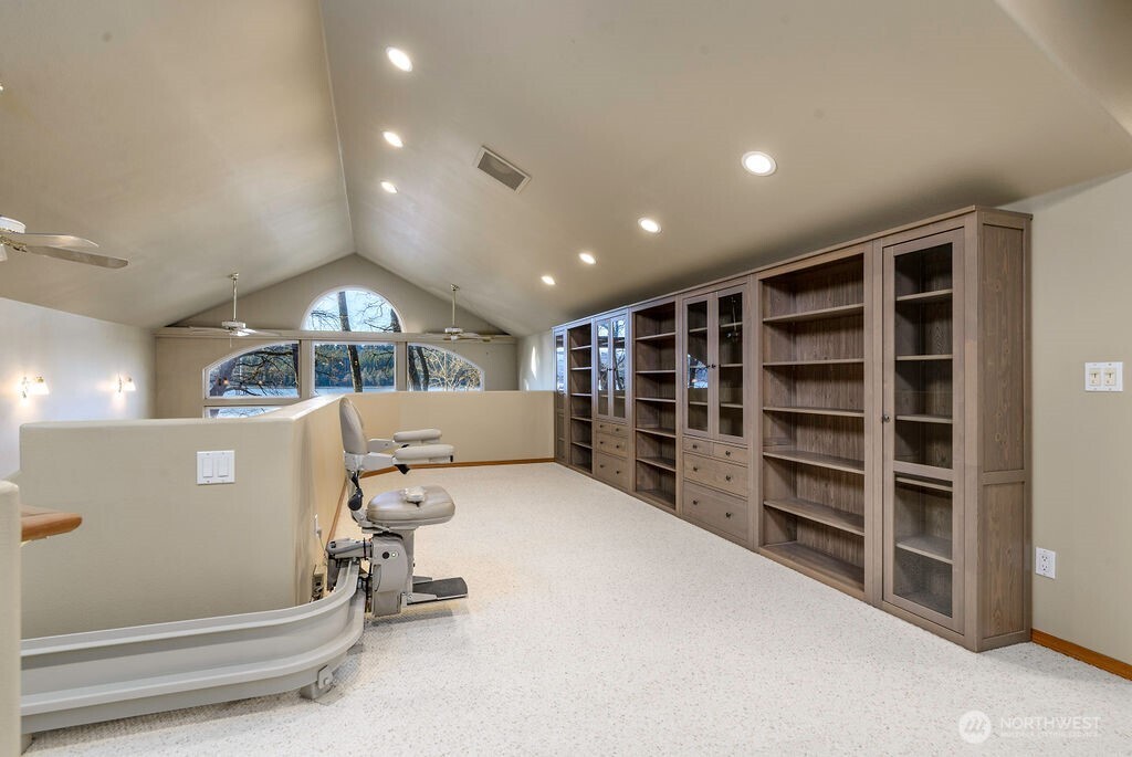 3250 Highway 302 Belfair, WA 98528 - Photo 16 of 40 a view of an empty room with a bookshelf and a large window