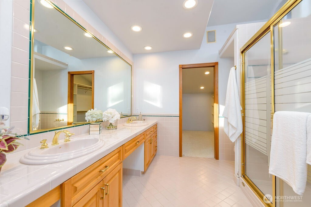 3250 Highway 302 Belfair, WA 98528 - Photo 19 of 40 a spacious bathroom with a granite countertop sink and a mirror