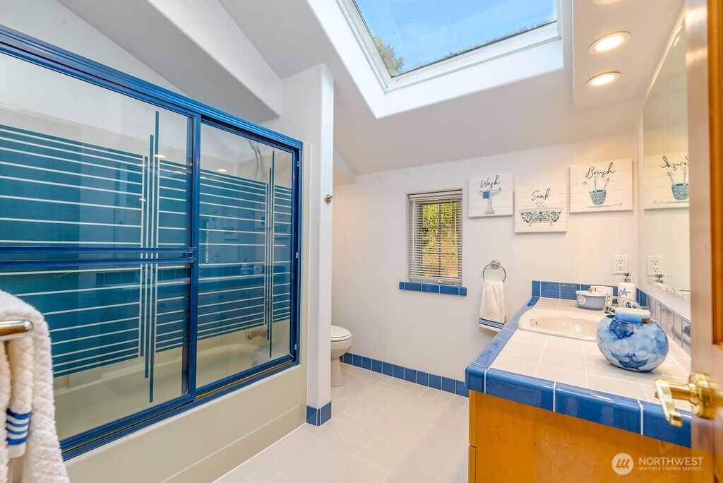 3250 Highway 302 Belfair, WA 98528 - Photo 25 of 40 a bathroom with a sink and a mirror
