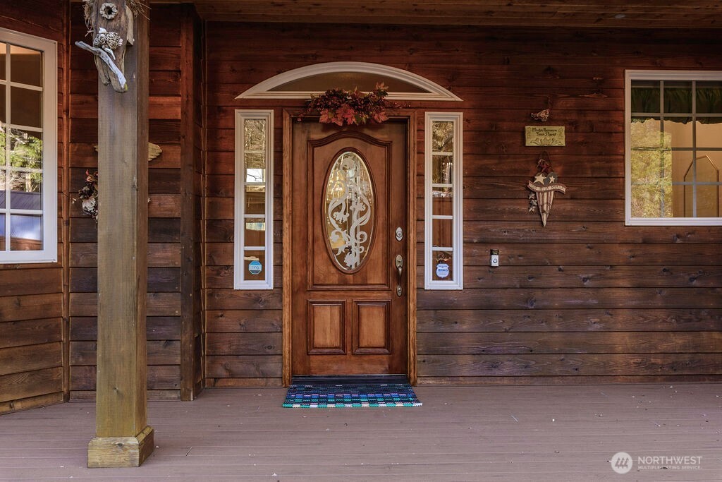 3250 Highway 302 Belfair, WA 98528 - Photo 6 of 40 a front view of a house with entryway