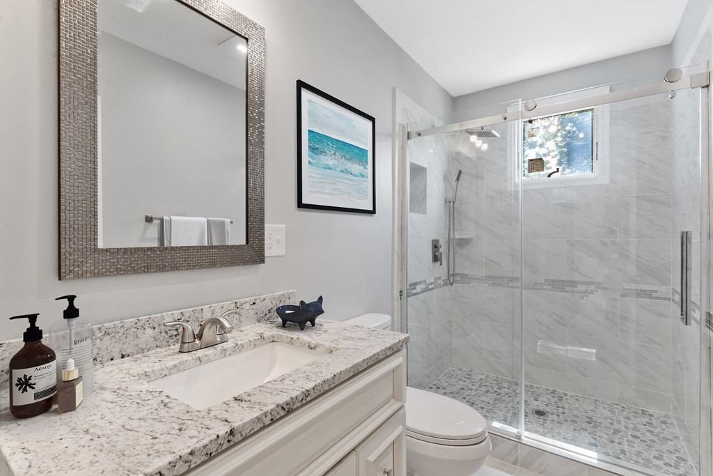 9 Wales Street, Unit 2 Boston, MA 02124 - Photo 5 of 15 a bathroom with a granite countertop sink toilet and shower