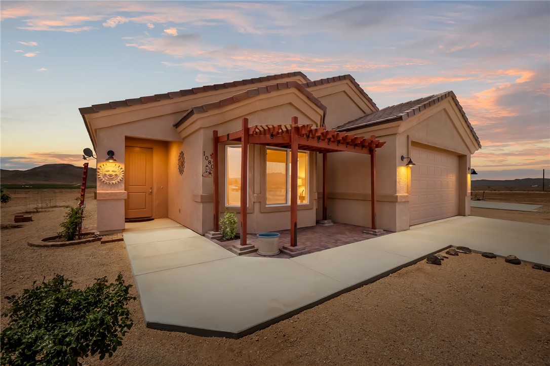 10809 North Jemez Road Kingman, AZ 86401 - Photo 1 of 51 Stucco exterior residence featuring a tiled roof and an attached two-car garage