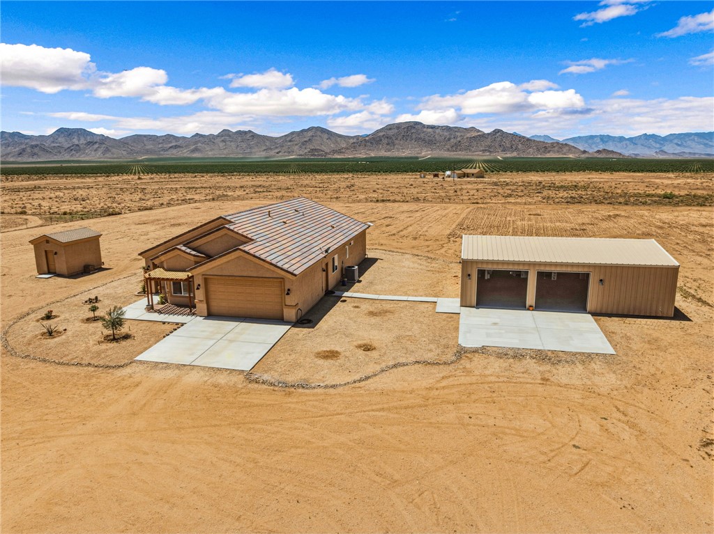 10809 North Jemez Road Kingman, AZ 86401 - Photo 2 of 51 Desert property featuring a single-story residence with a concrete driveway, attached garage, and tiled roofing