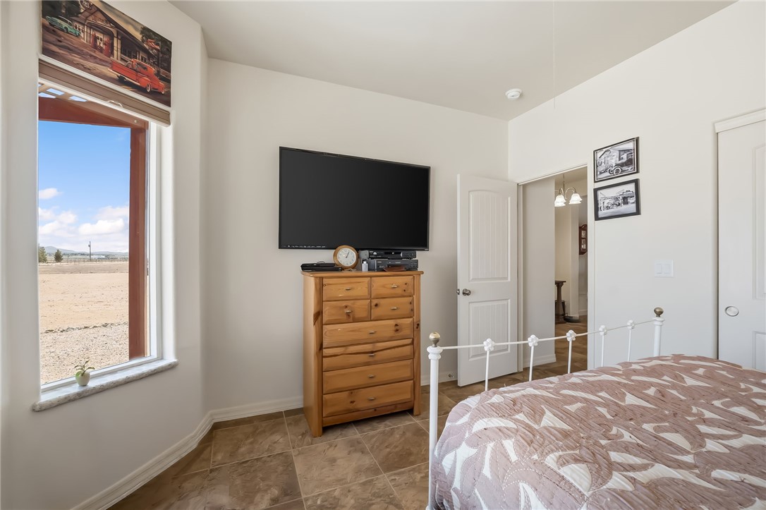 10809 North Jemez Road Kingman, AZ 86401 - Photo 25 of 51 Spacious room featuring tile flooring, white baseboards, and a large window with a granite-look sill