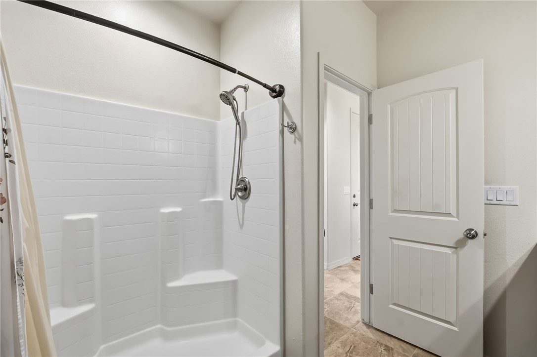 10809 North Jemez Road Kingman, AZ 86401 - Photo 28 of 51 Walk-in shower featuring white tile-look surround and brushed nickel fixtures