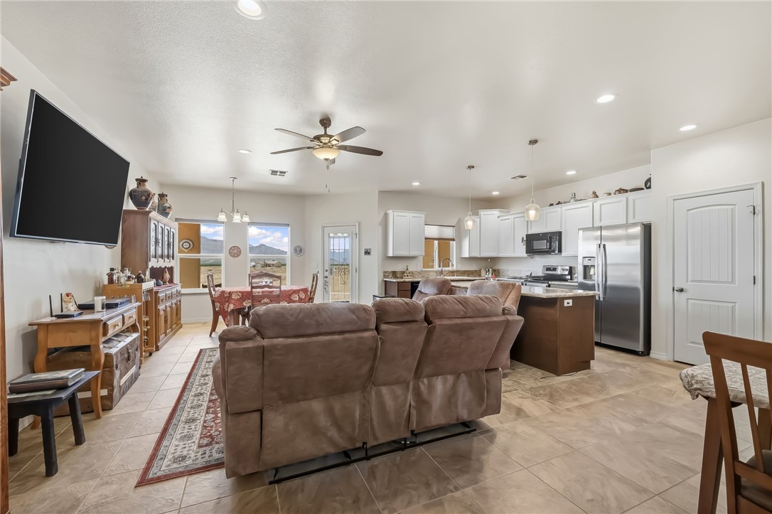 10809 North Jemez Road Kingman, AZ 86401 - Photo 29 of 51 Open-concept living space featuring neutral tile flooring, recessed lighting, and a ceiling fan