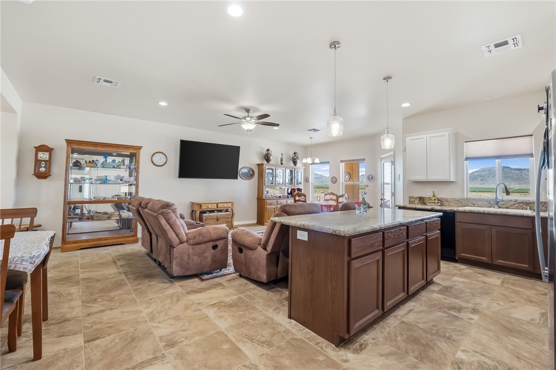 10809 North Jemez Road Kingman, AZ 86401 - Photo 35 of 51 Spacious open-concept interior featuring large format tile flooring, a kitchen island with pendant lighting, stone countertops, and recessed lighting