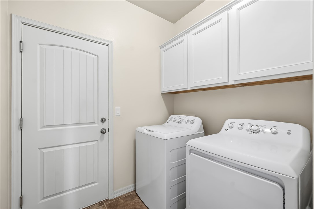 10809 North Jemez Road Kingman, AZ 86401 - Photo 38 of 51 Dedicated laundry area featuring white upper cabinetry with crown molding, a wood-finish shelf, and neutral-toned wall paint