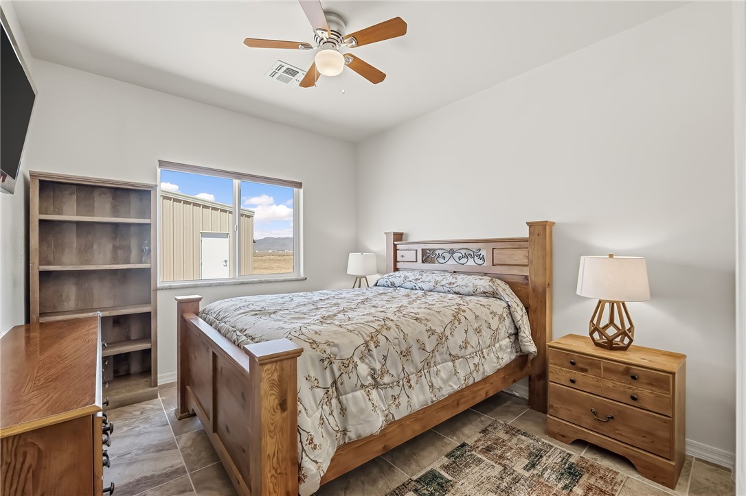 10809 North Jemez Road Kingman, AZ 86401 - Photo 41 of 51 Spacious room featuring tile flooring, a window offering natural light, and a ceiling fan