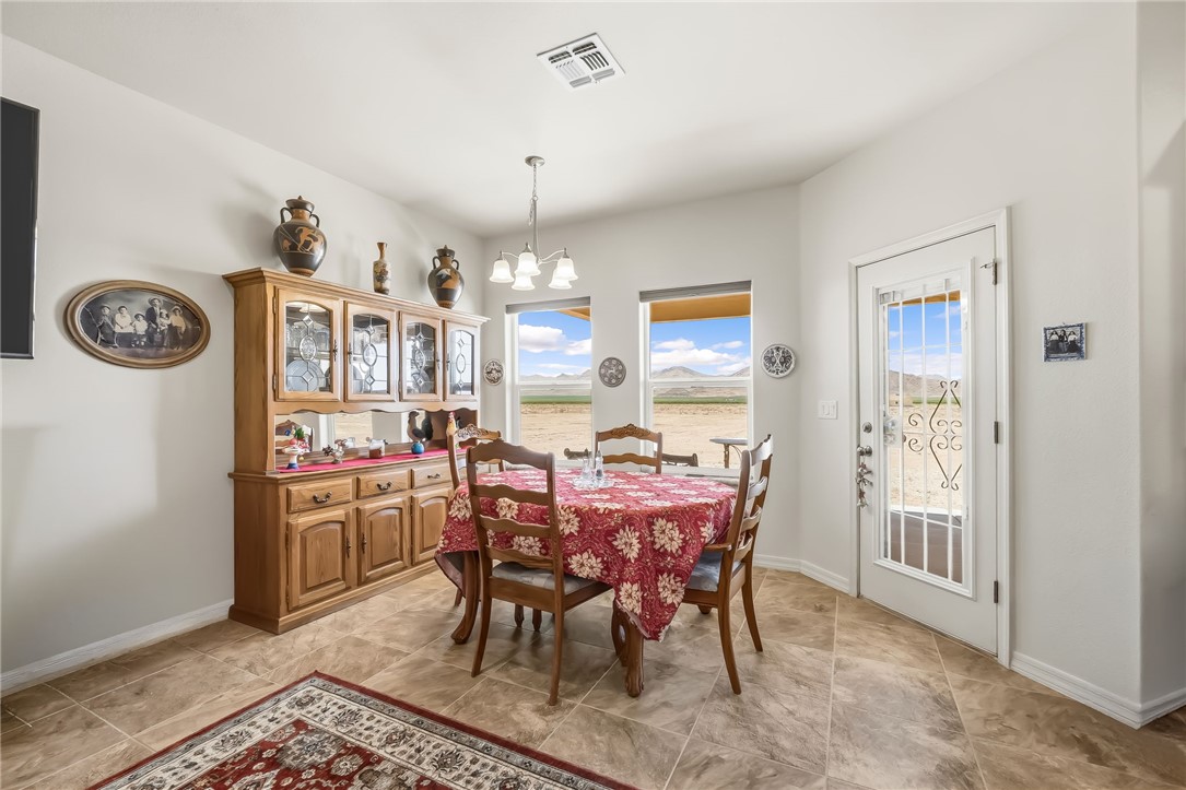 10809 North Jemez Road Kingman, AZ 86401 - Photo 9 of 51 Light-filled dining area featuring neutral wall tones, recessed lighting, and tile flooring