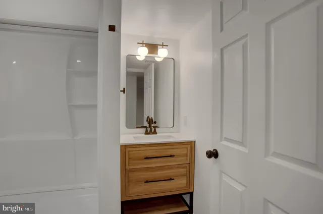 a bathroom with a sink a vanity and a mirror