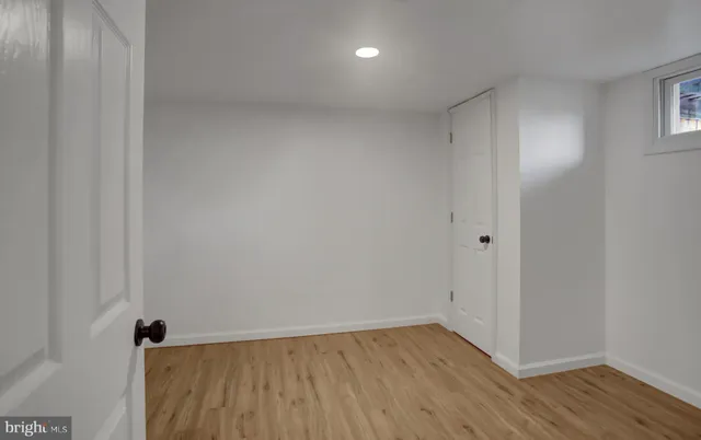 a view of an empty room with wooden floor