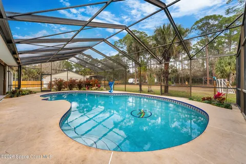 a view of a swimming pool with a patio