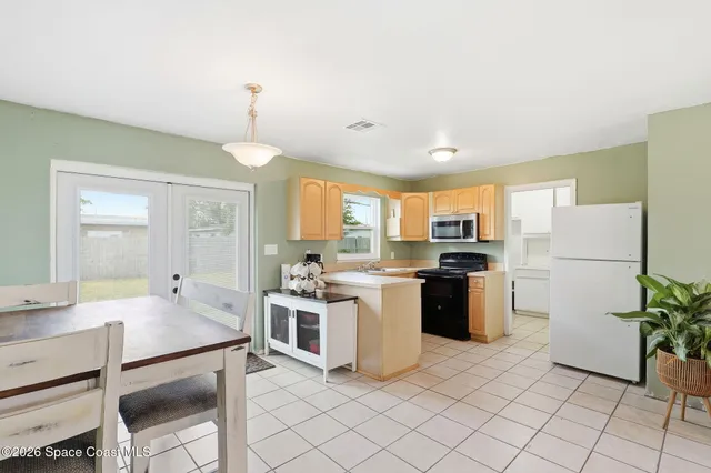 a kitchen with a refrigerator and a stove