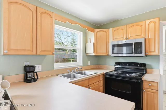 a kitchen that has a sink and a stove top oven