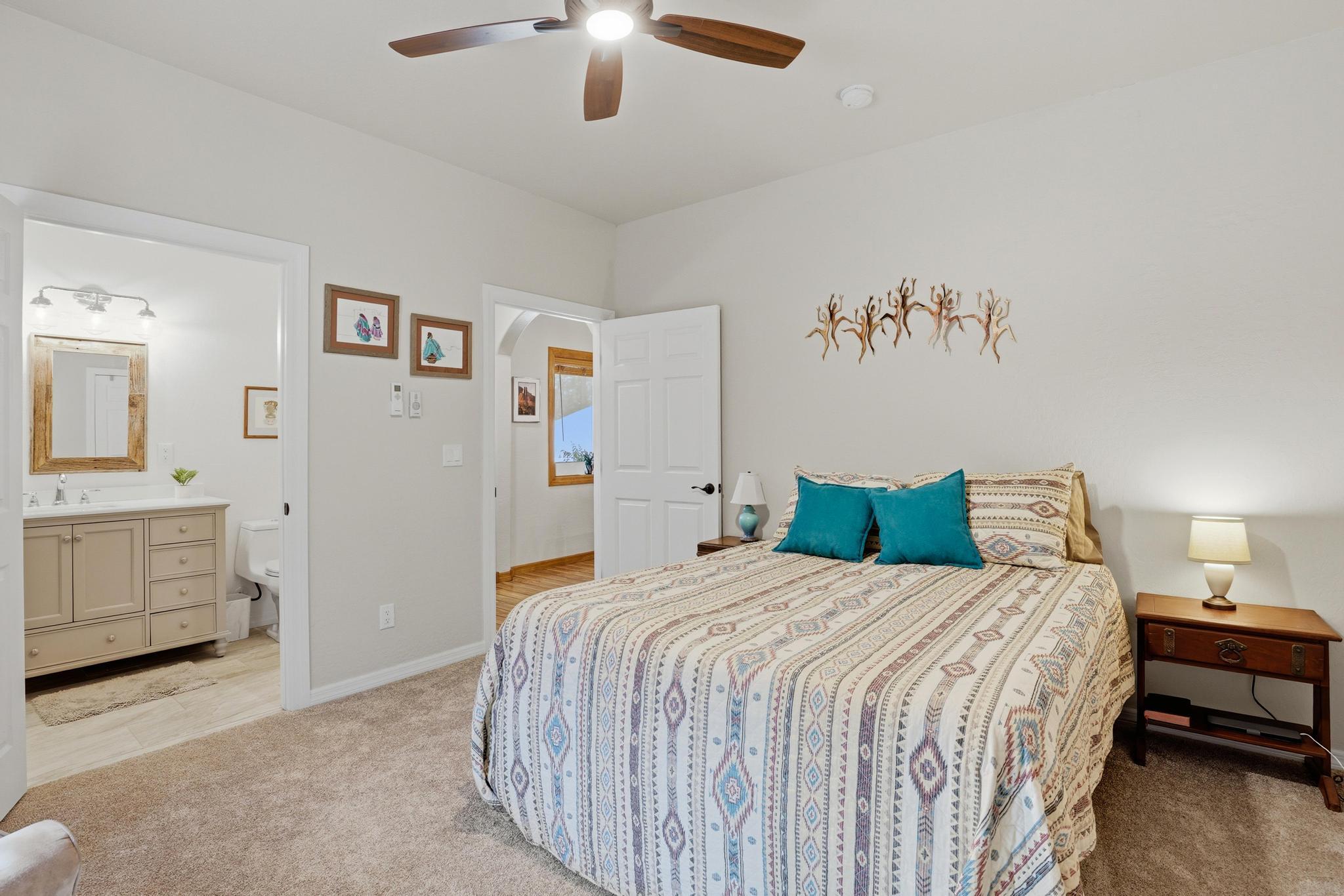 5501 Solitude Trail Loop Pine, AZ 85544 - Photo 18 of 27 a bedroom with a bed and a chandelier