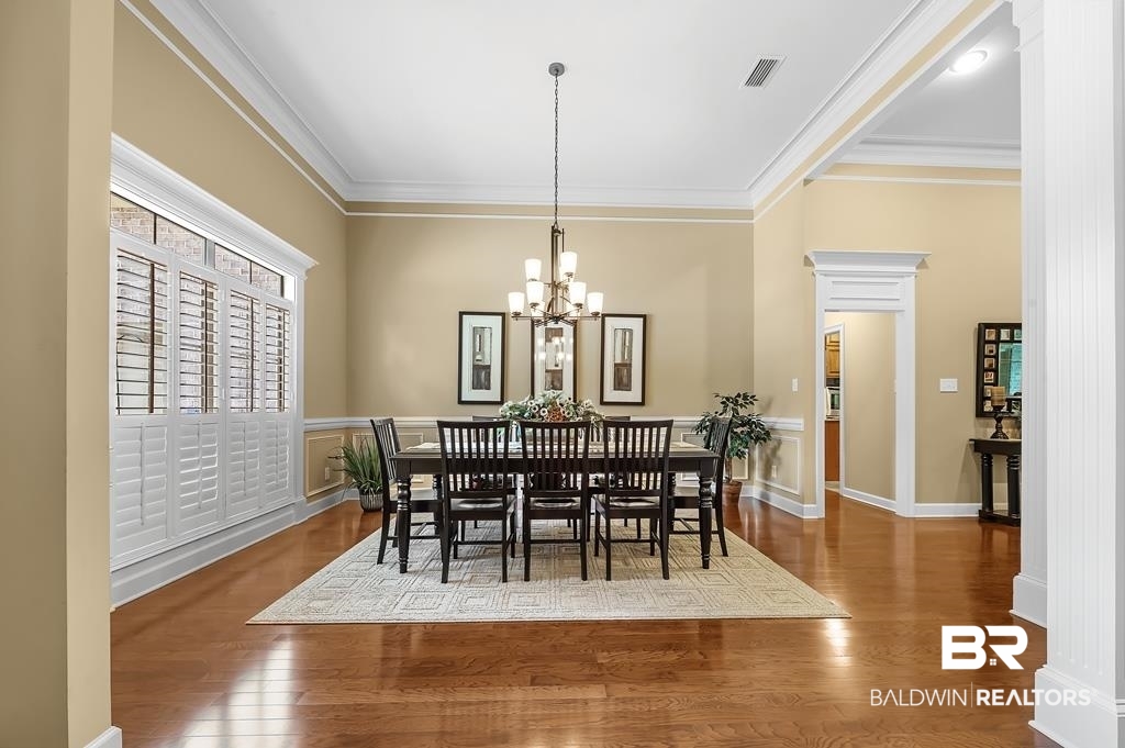 29976 Dolive Ridge Daphne, AL 36527 - Photo 12 of 58 Dining space featuring hardwood / wood-style flooring, a notable chandelier, and ornamental molding