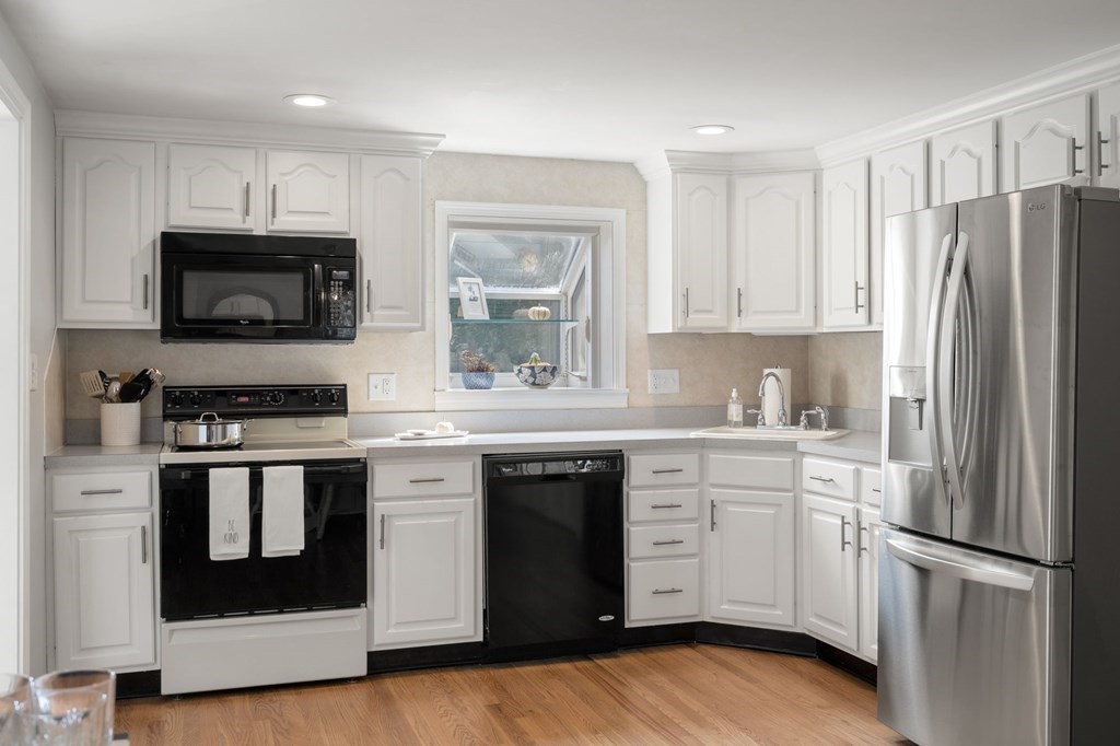 61 Colasanti Road Weymouth, MA 02191 - Photo 9 of 37 a kitchen with stainless steel appliances a stove microwave and sink