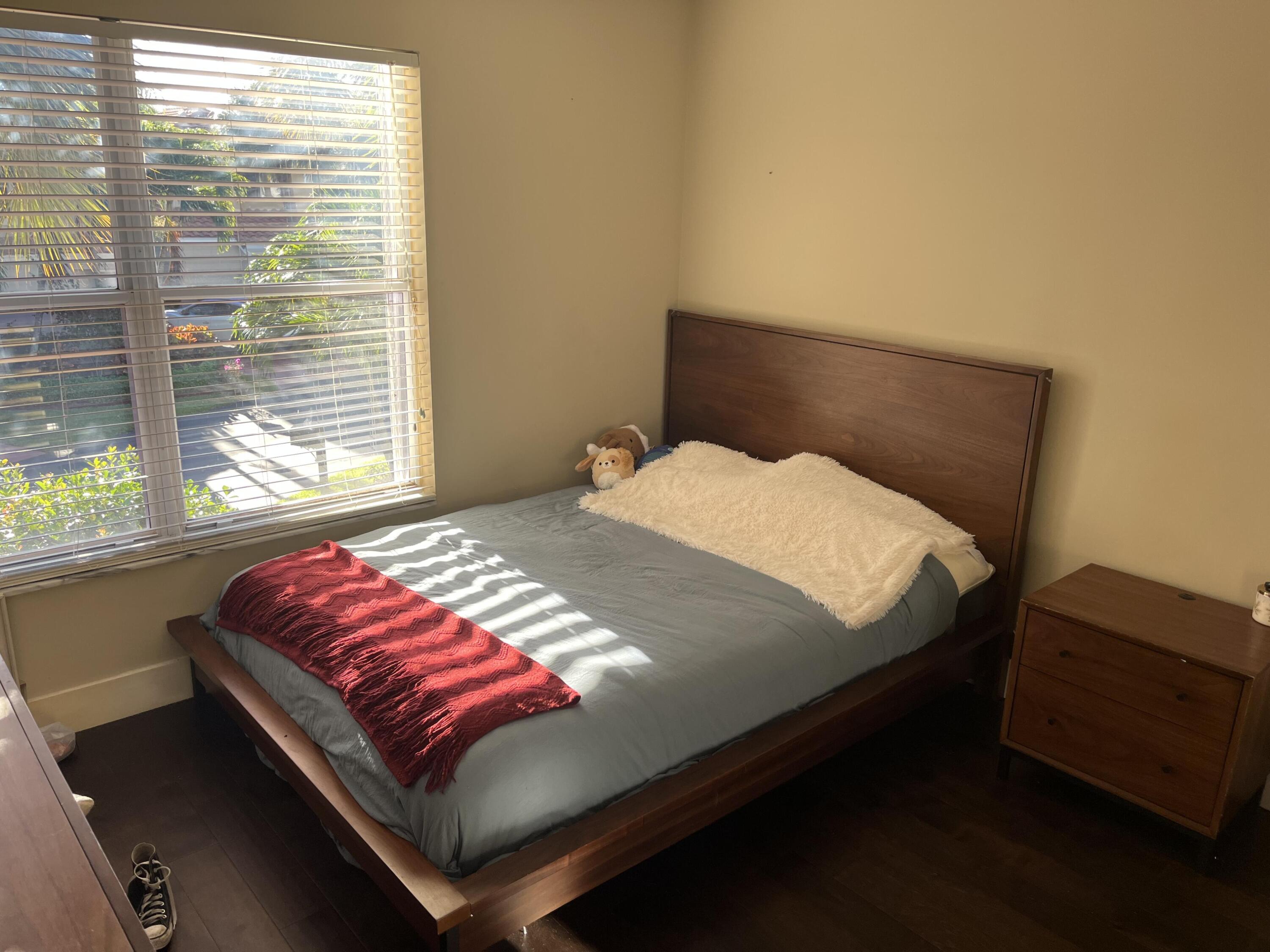 17651 Tiffany Trace Drive Boca Raton, FL 33487 - Photo 15 of 17 a bedroom with a bed and window