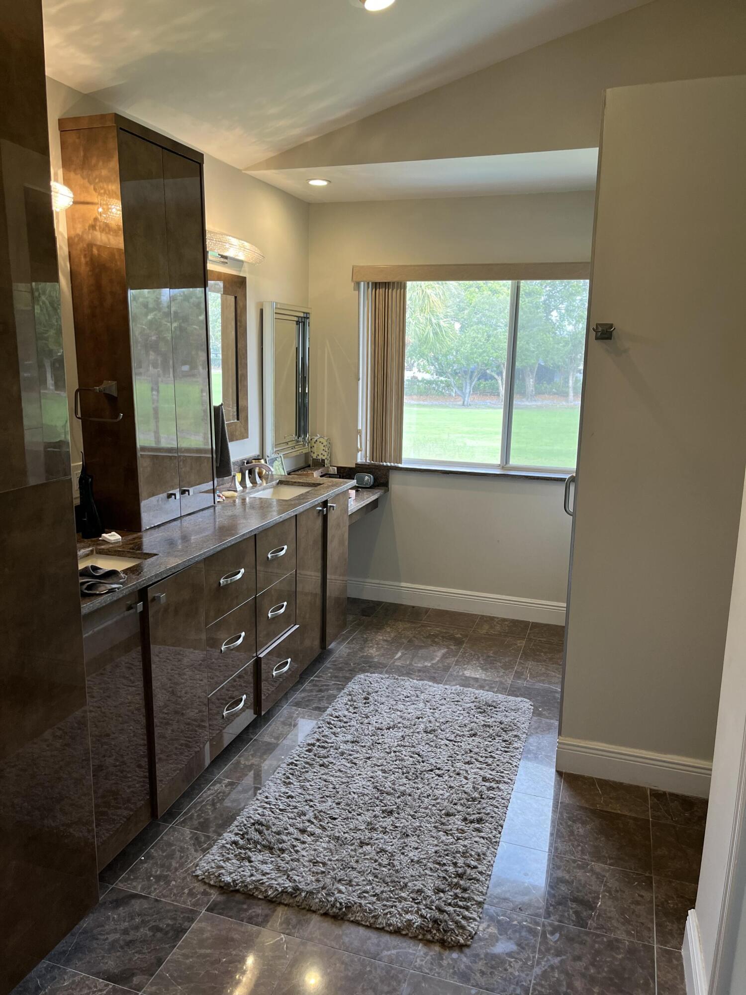 17651 Tiffany Trace Drive Boca Raton, FL 33487 - Photo 10 of 17 a bathroom with a double vanity sink and a mirror